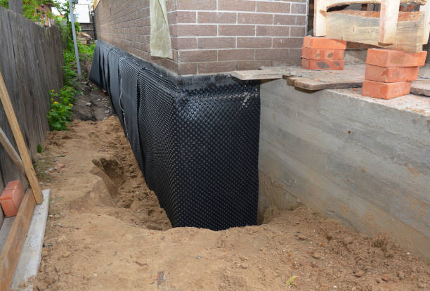 Happy homeowners after waterproofing job in Grady